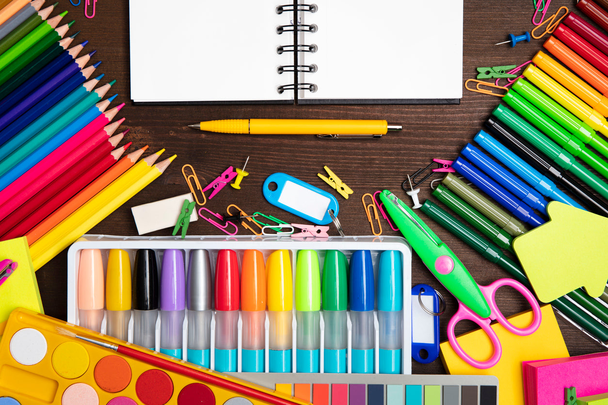 color school supplies spread out on a desk