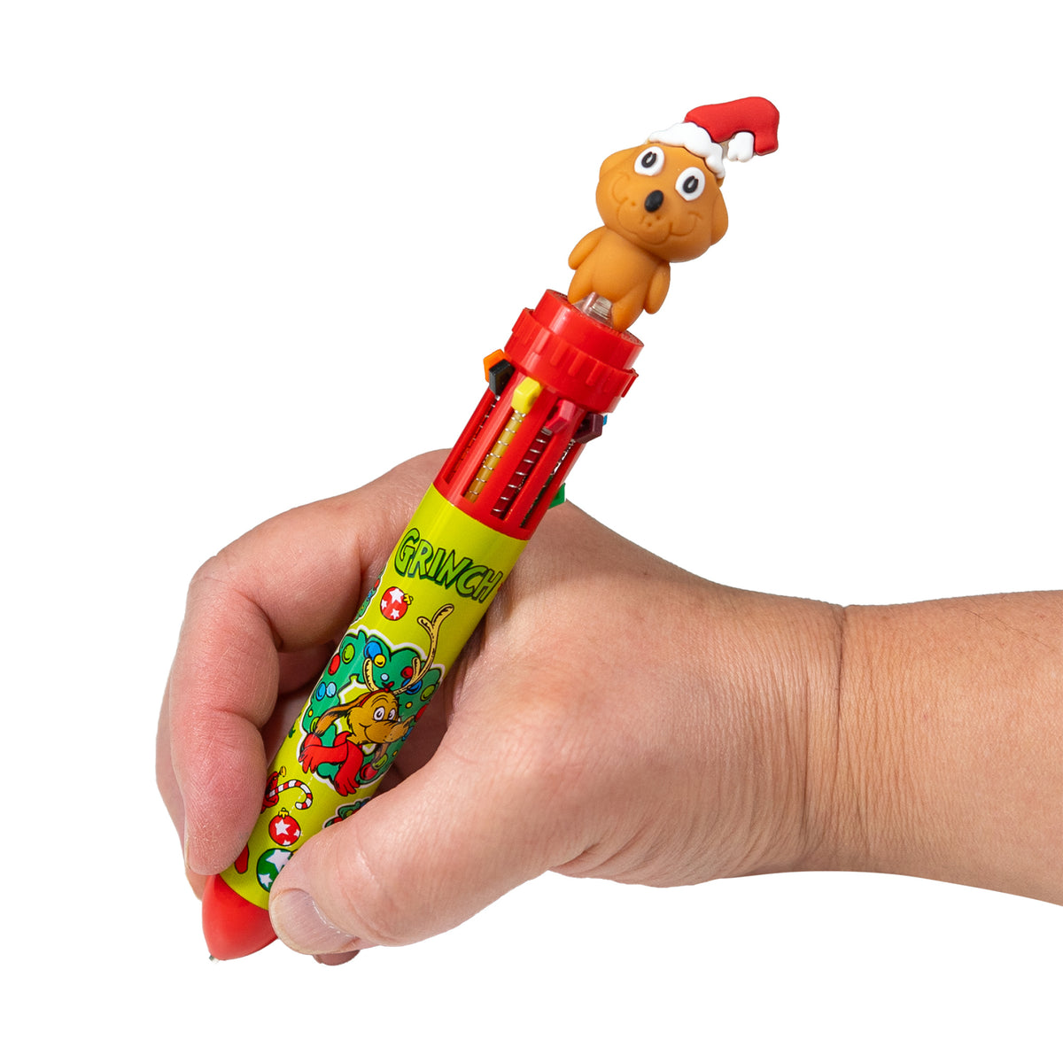 Hand writing with the red Dr. Seuss™ Grinch 10-color pen featuring Max in a Santa hat.