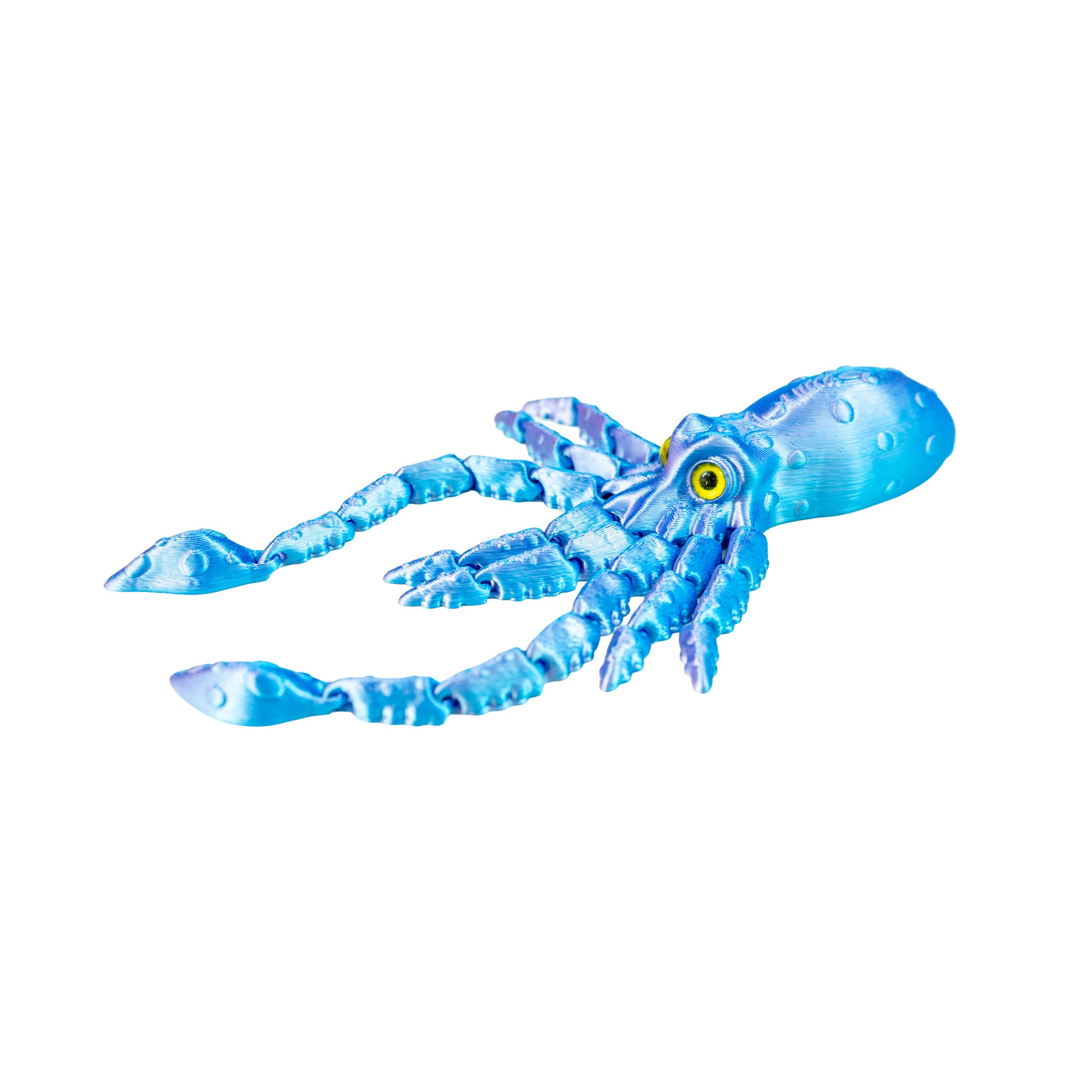 Blue 3D-printed squid fidget toy lying on a white background with its articulated arms and long tentacles extended.