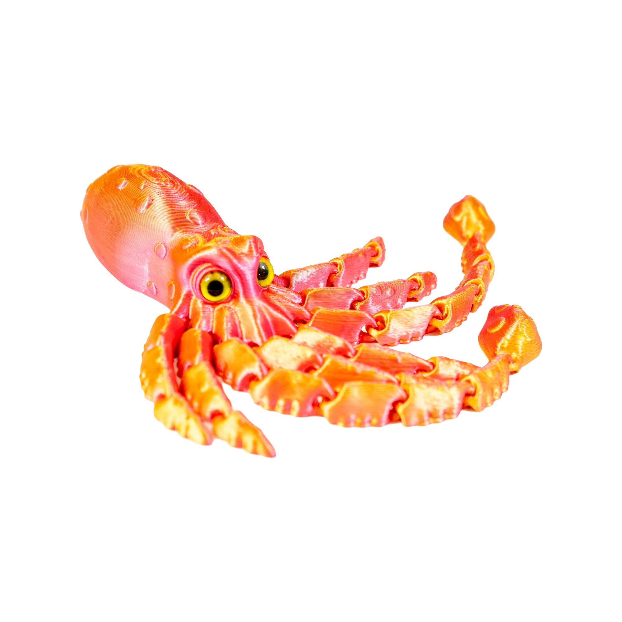 Orange and pink 3D-printed squid fidget toy lying on its side with articulated arms and curled tentacles.