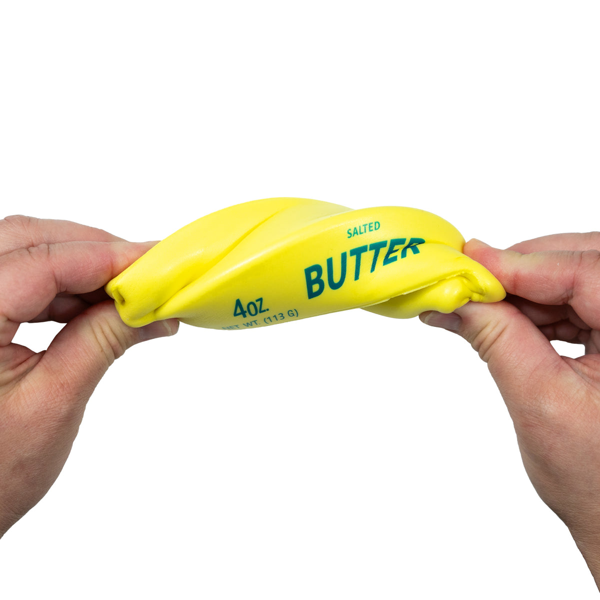 Hands twisting the yellow Squeeze Butter toy to show its flexibility.