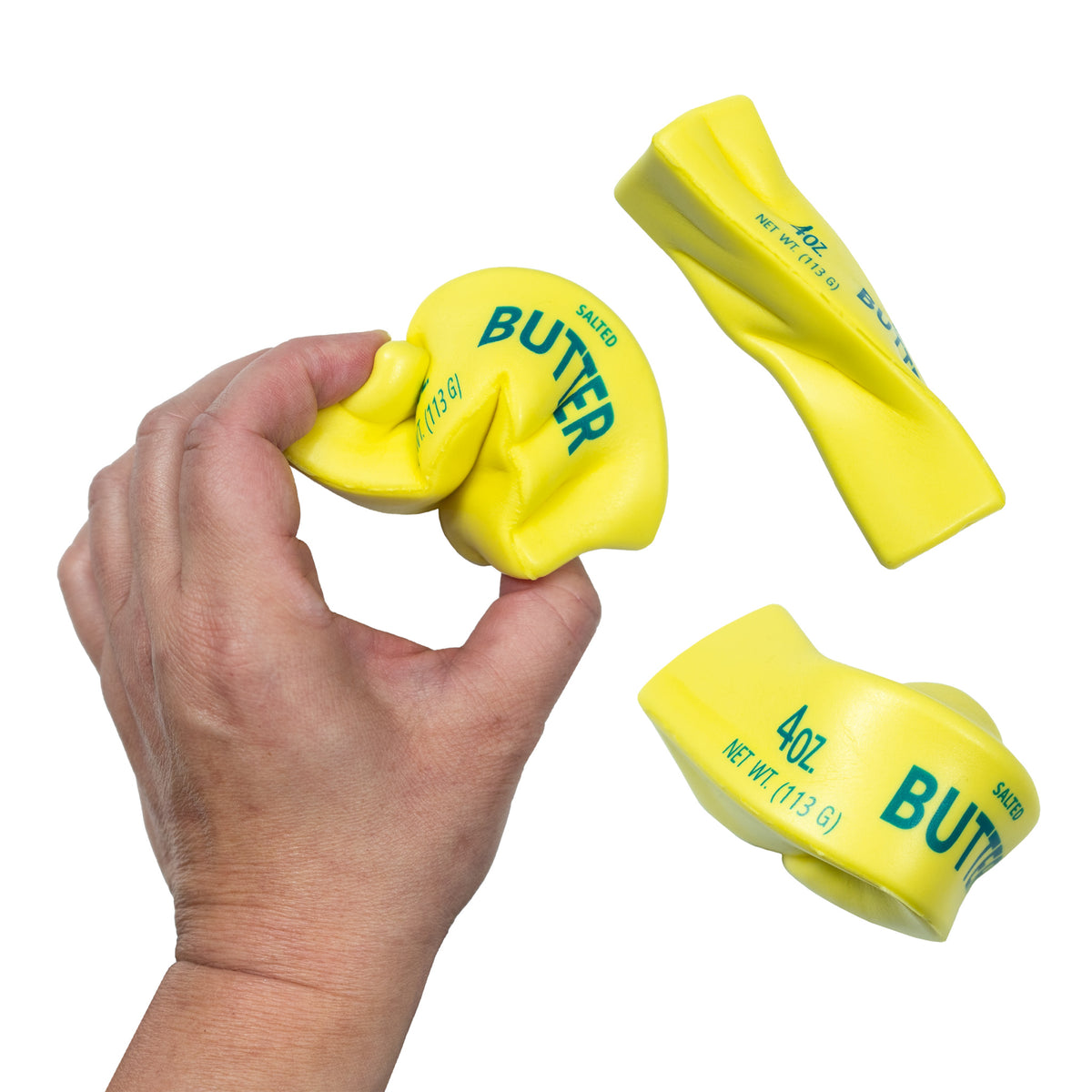 A hand squeezes the yellow Squeeze Butter toy, with two other bent and stretched views beside it.