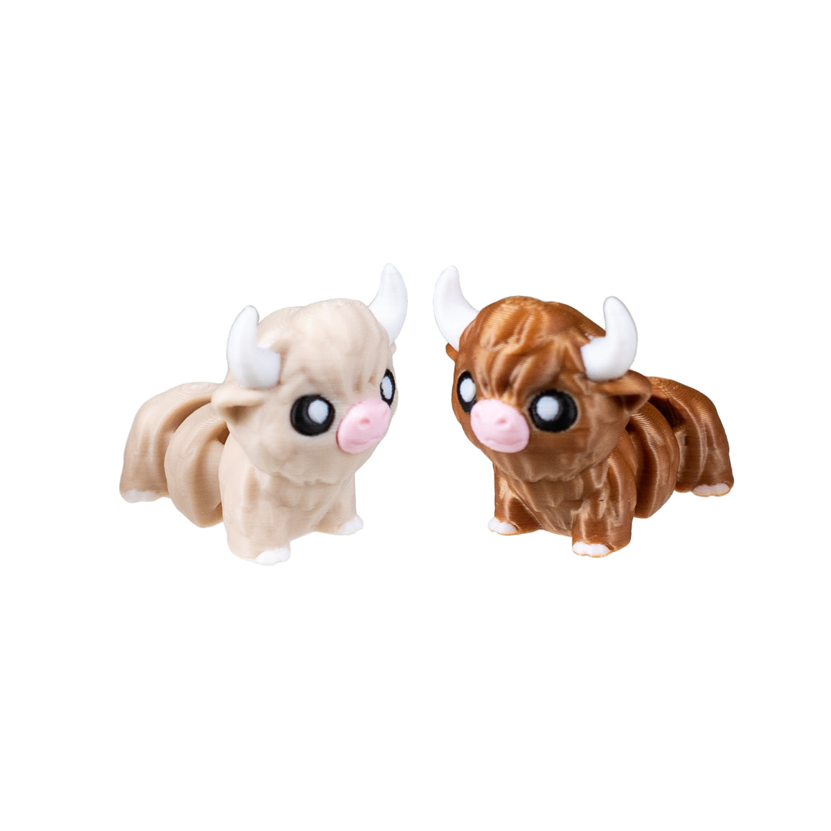 Angled view of light tan Maple and dark brown Moose 3D Printed Highland Cow Fidgets.